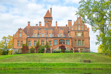 Old red castle with orange roof at Latvia.