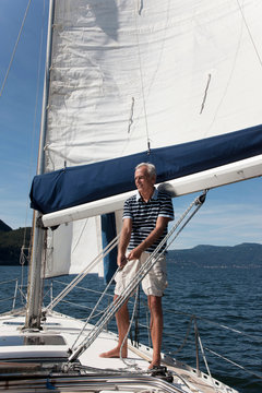 Older Man Sailing On Lake