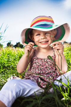 Toddler Girl Wearing Sunhat In Grass