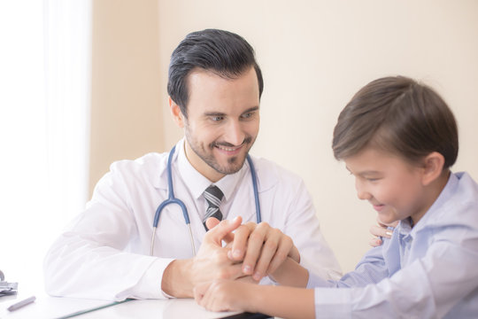 Attractive Doctor working at hospital. Doctor try to treat Kid for any problem.