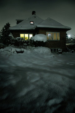 Snow covered house and front yard