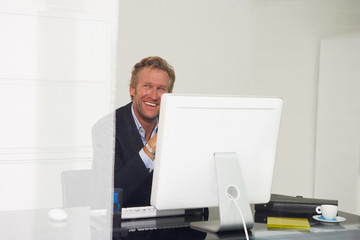 Man at computer smiling