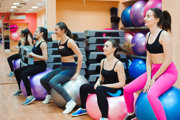 Beautiful caucasian women doing exercise with gymnastic ball.