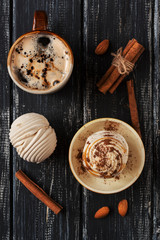 Marshmallows and coffee on a rustic background, top view. Sweet dessert