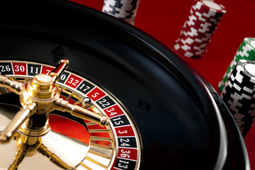 Gambling, casino games and the gaming industry concept with five the winning number, 5 is a red number on the roulette wheel