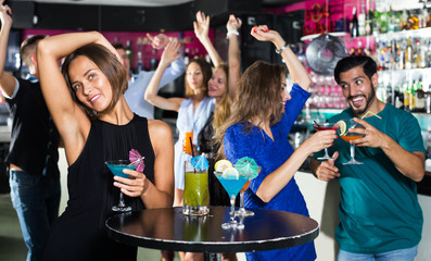 Naklejka na ściany i meble Woman enjoying party in bar