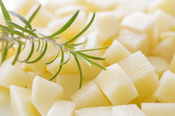 Diced raw potatoes with rosemary.