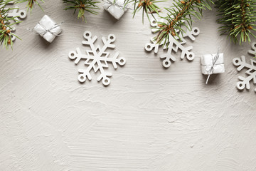 Christmas decorations - gifts, snowflakes and spruce tree on white wall