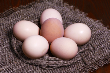 Easter eggs nosheshkivine in the form of a nest on a wooden table. View from above