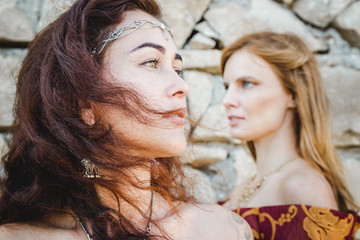 two women faces that stand back to wall