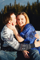 Beautiful young couple over amazingly snowy mountains