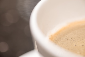 Close up of white cup of hot Espresso coffee on wooden table