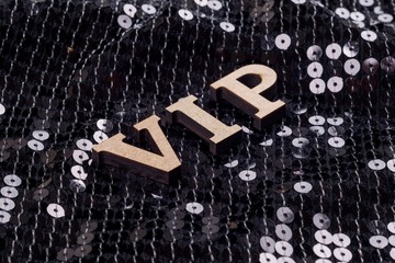 Fototapeta na wymiar VIP is written in abstract letters. Black luxurious sparkling background