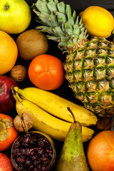 Exotic fruits on a wooden board. Healthy food. Nutrition for athletes.