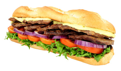 Beef steak and salad filled crusty baguette sandwich isolated on a white background