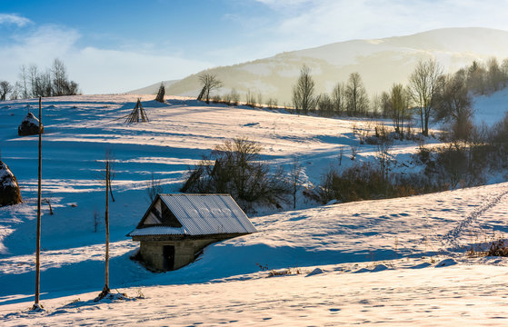 shed on snow covered agricultural hillside. lovely rural scenery in winter