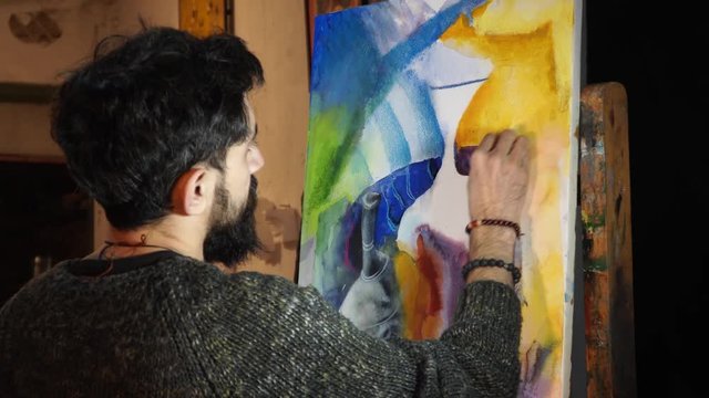 artist paints an abstract picture of mixed technique - watercolor and pastel - 4k video