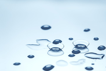 contact lenses with water drops on reflective surface.