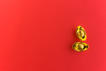 Chinese New Year Background - Golden Ingots with Chinese Character Happiness and Prosperity on Red Background.