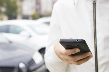 hand with outdoor mobile phone