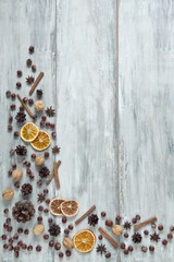 Traditional Christmas background with cinnamon sticks, cones, anise and dry orange slices. Top view, background, Christmas concept. place for your text
