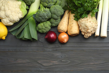 Fresh vegetables on dark wooden background. Mockup for menu or recipe. Top view with copy space