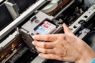 closeup shot young female technician repairing digital printer