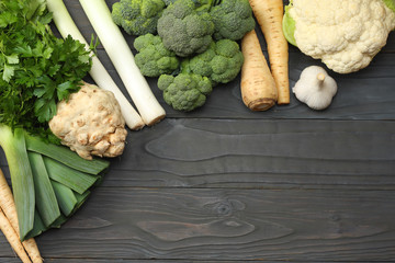 Fresh vegetables on dark wooden background. Mockup for menu or recipe. Top view with copy space