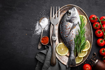 Fresh raw dorado fish on black background, top view