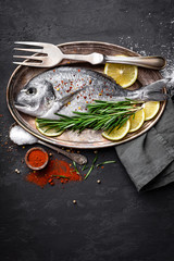 Fresh raw dorado fish on black background, top view
