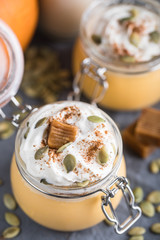 Pumpkin milkshake with salted caramel, orange, seads and wipped cream