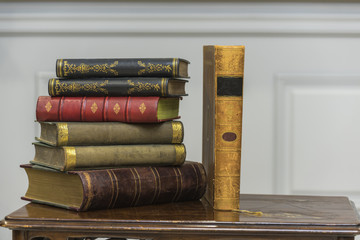 A stack of old books on the coffee table.