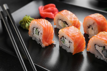 Plate with tasty sushi rolls, closeup