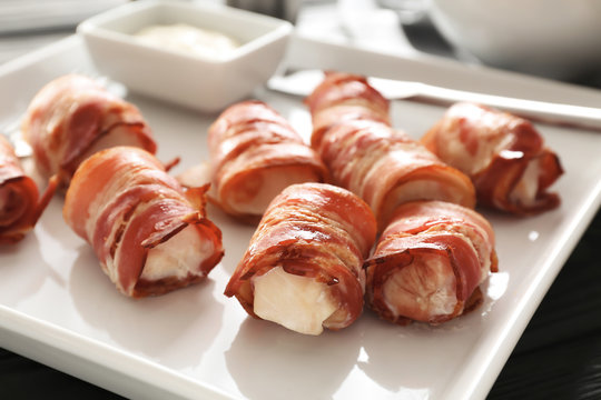 Plate with bacon wrapped chicken nuggets, closeup