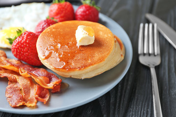 Tasty breakfast with pancakes and bacon on plate, close up © Africa Studio