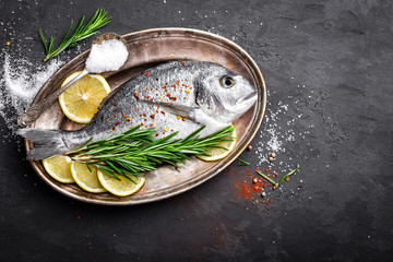 Fresh raw dorado fish on black background, top view
