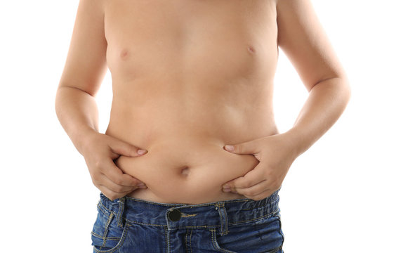 Overweight boy on white background, closeup