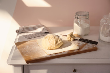 Raw puff pastry on wooden board