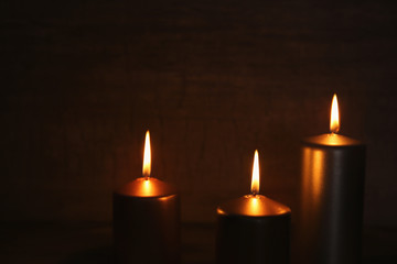 Burning candles on dark background
