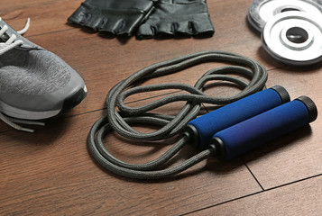 Composition with jumping rope on wooden background