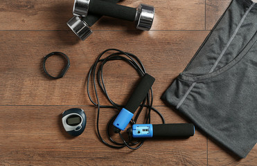 Composition with jumping rope on wooden background