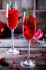 Pomegranate champagne mimosa cocktail with rosemary