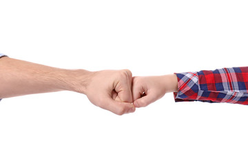 Cute little child and father bumping fists on white background