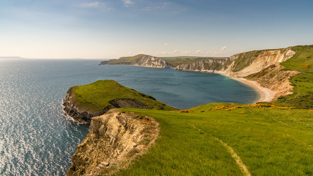 Walking on the South West Coast Path, looking at Worbarrow Bay, near Tyneham, Jurassic Coast, Dorset, UK