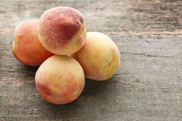 Ripe peaches fruit on grey wooden table