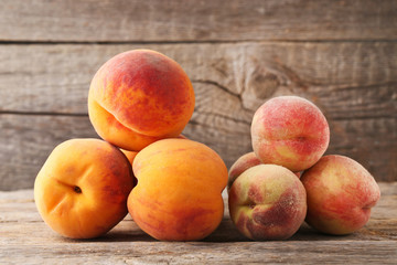 Fototapeta na wymiar Ripe peaches fruit on grey wooden table