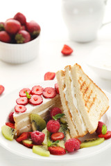 Toasts bread with various berries on white wooden table