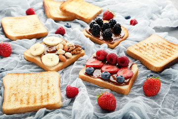 Toasts bread with berries on gauze fabric