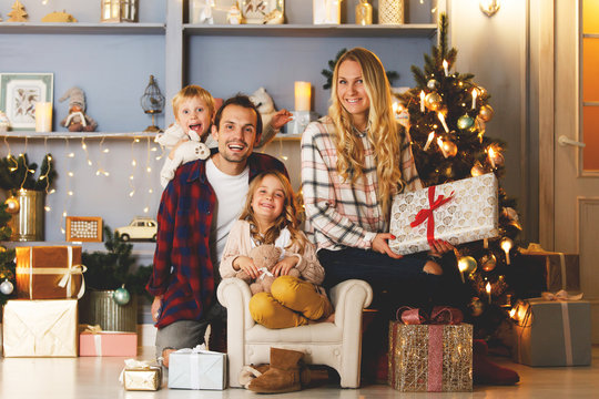 New Year's picture of happy family on background of Christmas decorations,pine