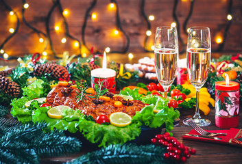 Naklejka na ściany i meble Christmas table dinner time with roasted meats decorated in Christmas style with glasses champagne. Background thanksgiving. The concept of a family holiday, delicious food.